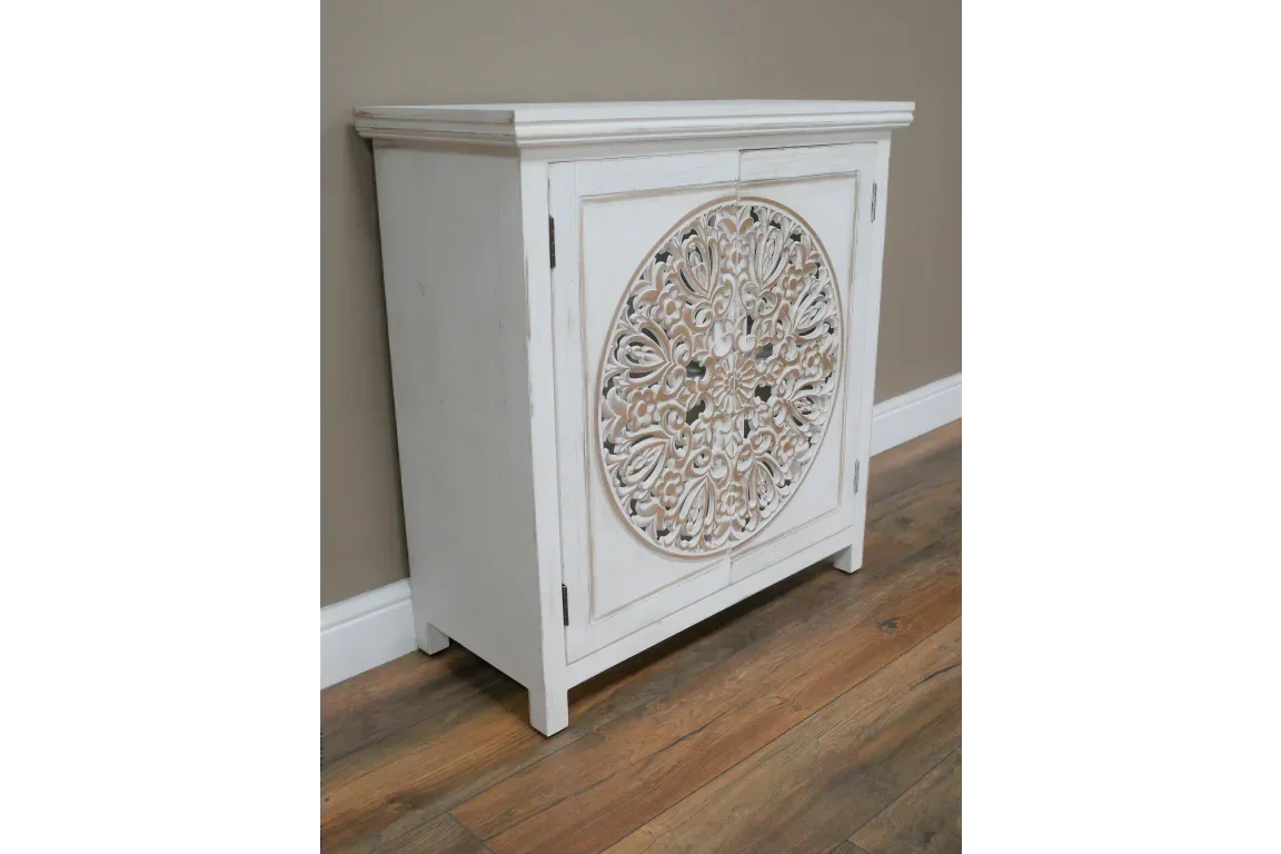 White wood sideboard cabinet with carved floral circular front panel on hardwood floor