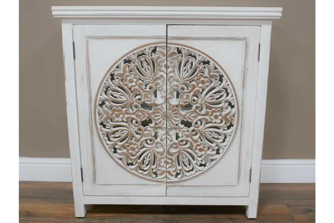 White wooden sideboard with distressed finish and ornate carved floral front design