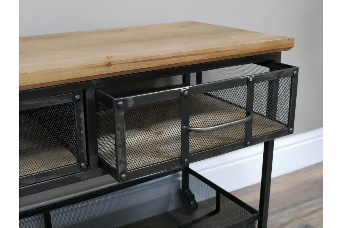 Industrial console table with metal mesh drawers and wooden top, close-up side view