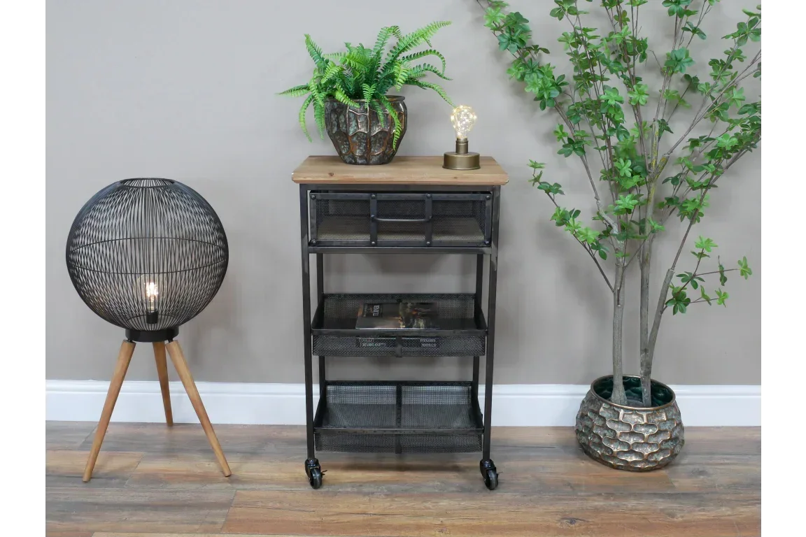 Industrial black metal storage trolley with wood top, shelving and caster wheels in a modern room