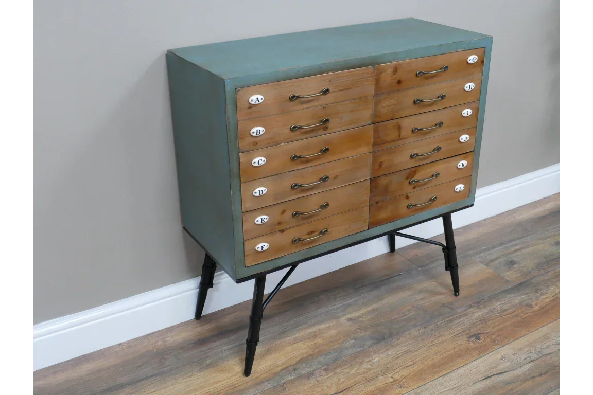 Mid-century chest of drawers with green frame, wooden drawer fronts, and black angled legs