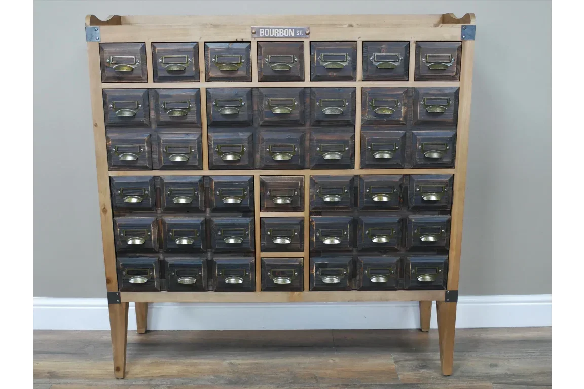 vintage wood chest with thirty dark drawers and metal pulls on angled legs