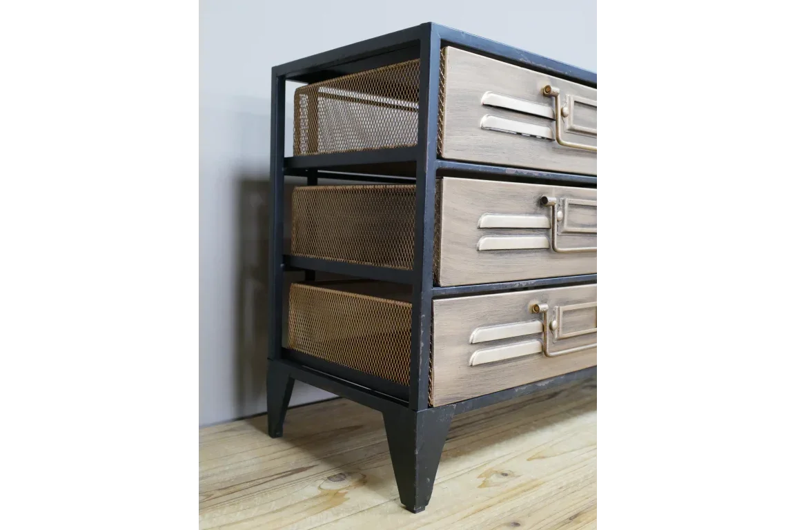 Industrial three drawer chest with metal mesh sides and wood fronts on light wood floor