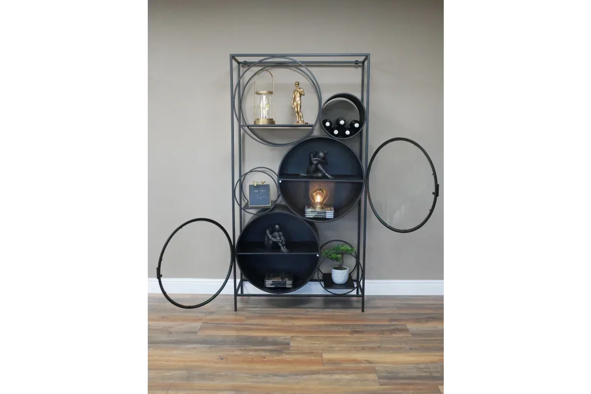 Black metal geometric shelving unit with circular shelves displaying decor and books