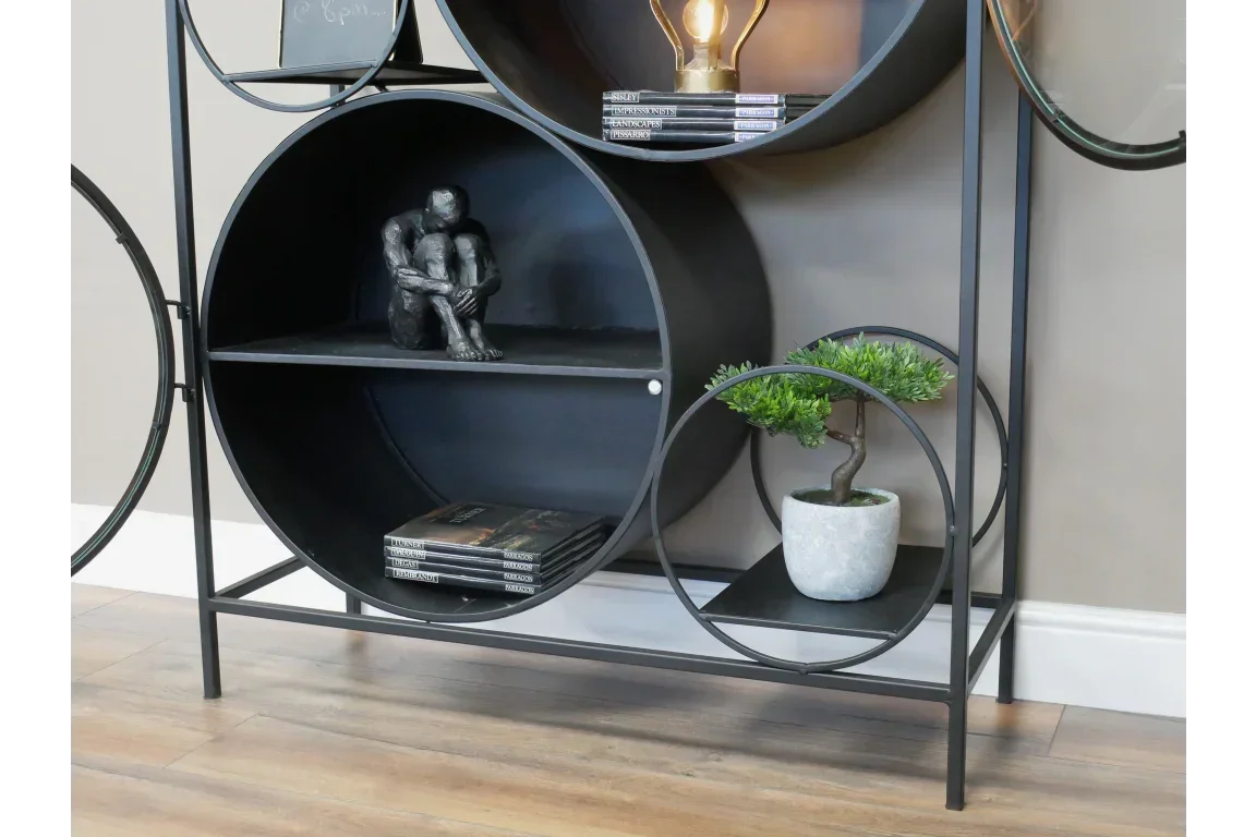 Modern circular metal shelf with black figurine, books, and potted plant