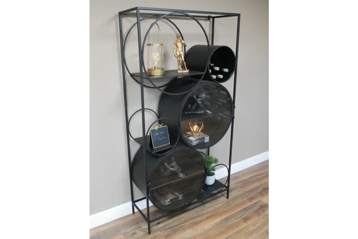 Black metal shelving unit with circular shelves, ornaments, books, and wine storage