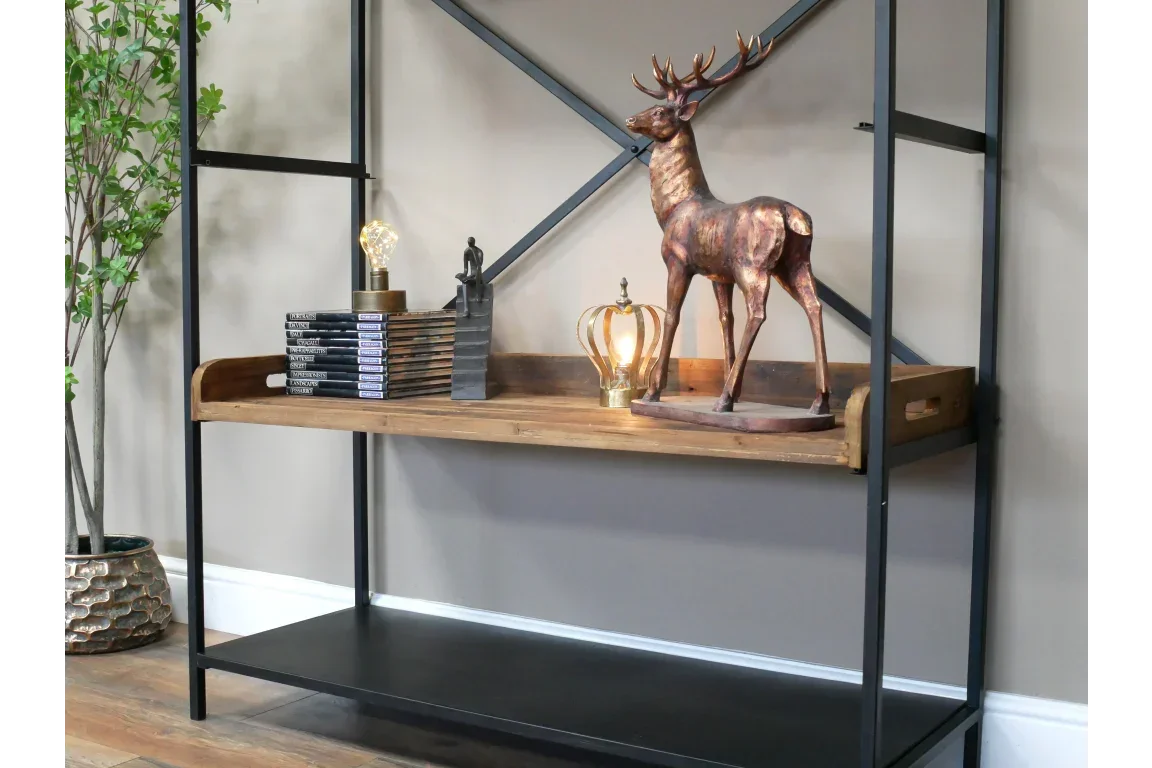 Industrial shelving unit with black metal frame and wood shelf, decorated with stag ornament