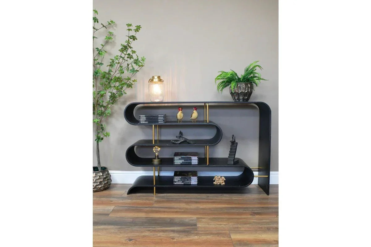 Black modern bookshelf with curved design and gold accents in a living room