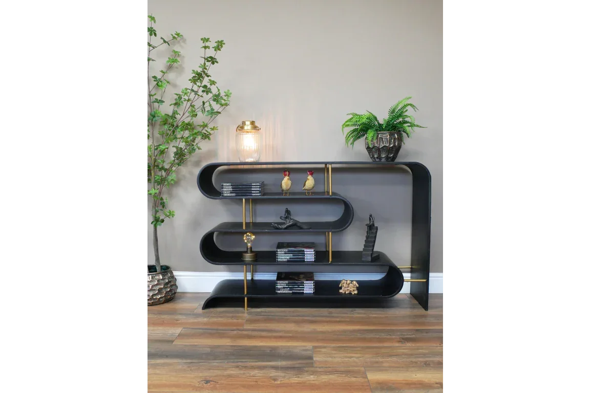 Black metal bookcase with curved shelves, gold accents and decorative ornaments in living room