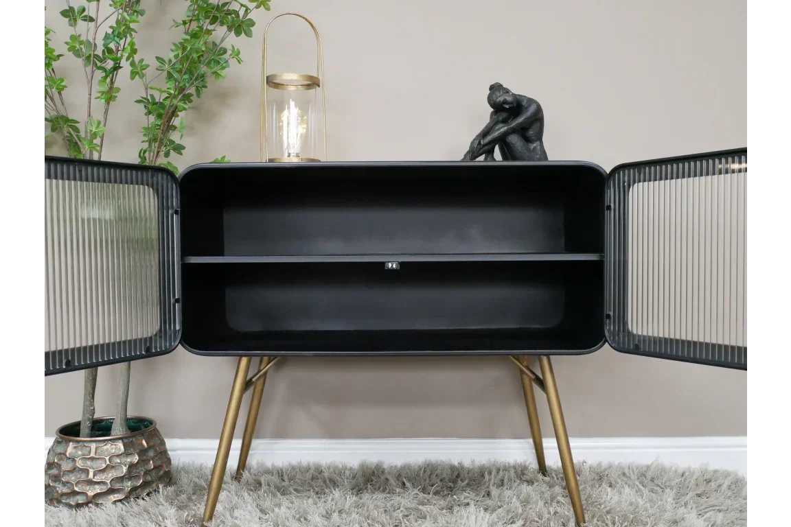 Black sideboard with ribbed glass doors, gold legs, and open shelf in modern living room