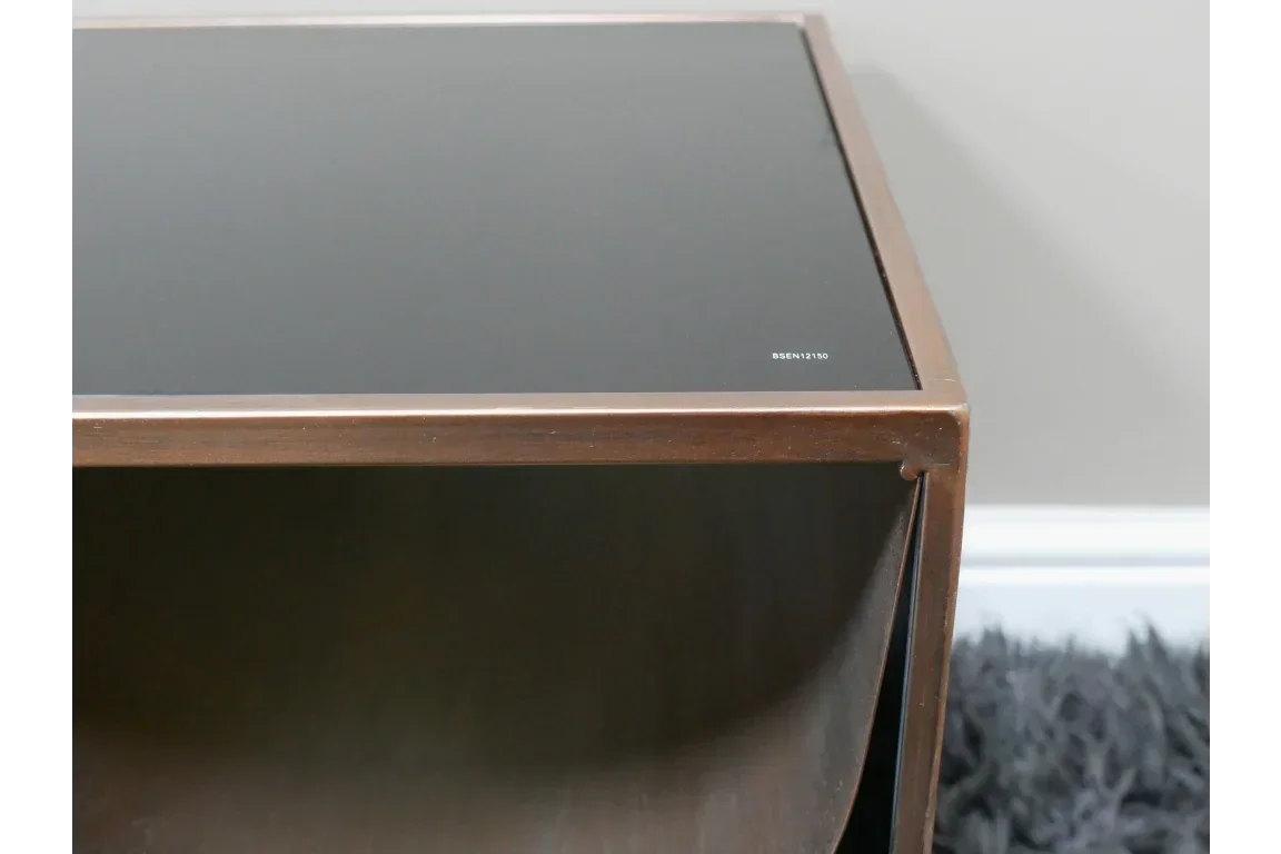 Brown wooden side table with black glass top and open storage compartment