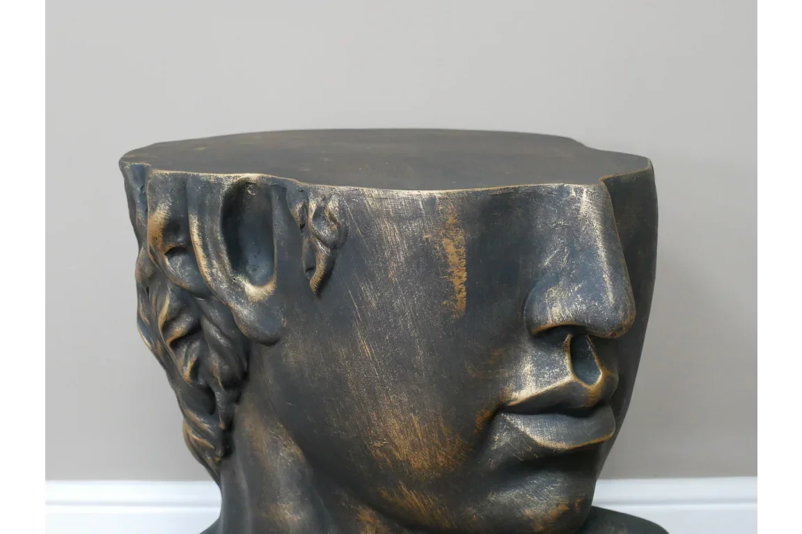 Bronze effect side table shaped like a classical head with detailed facial features