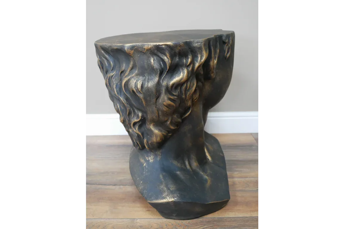 Bronze effect sculpted side table with classical head and textured hair detail on wood floor