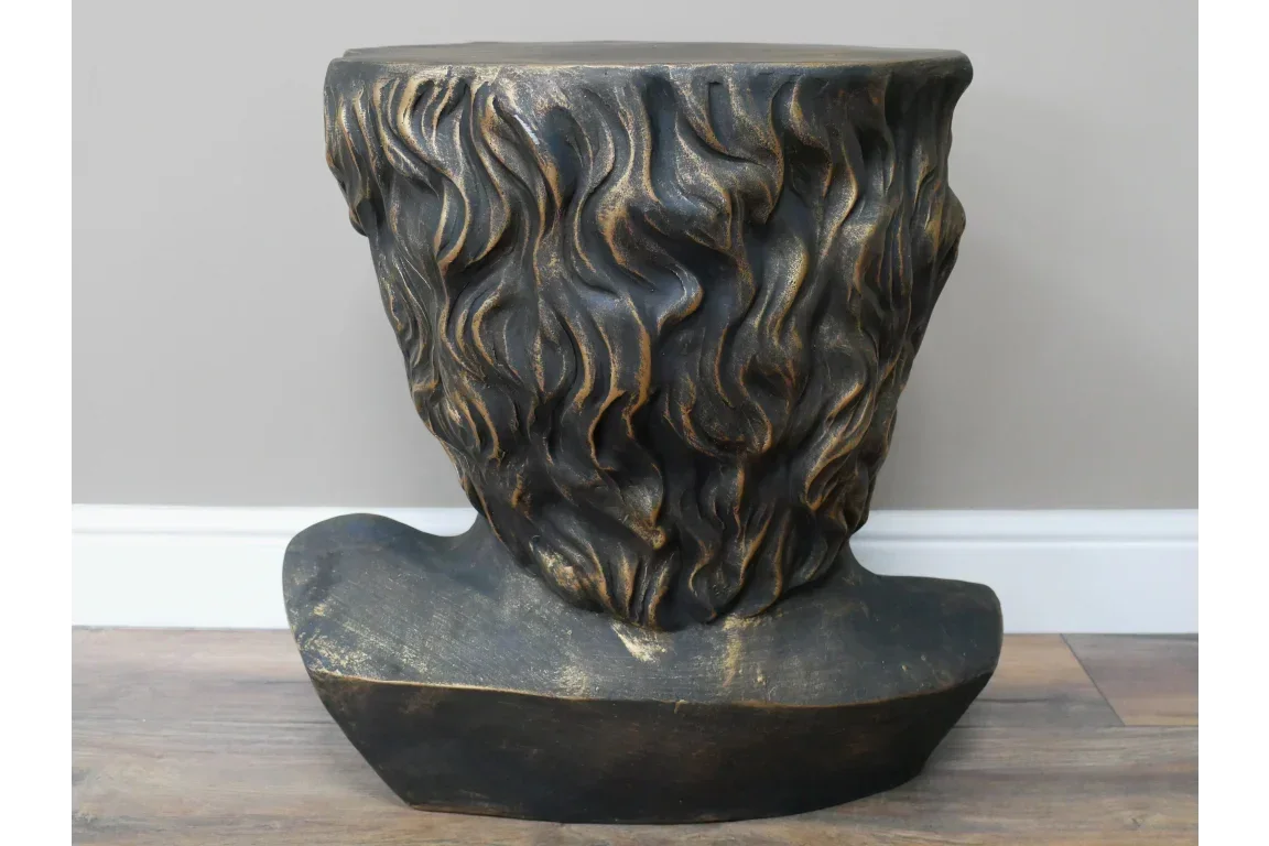 Bronze effect sculpted side table with textured hair design on wood floor