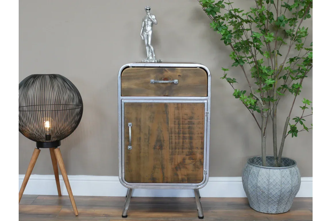 Industrial style wood and metal cabinet with drawer, styled with lamp and potted plant