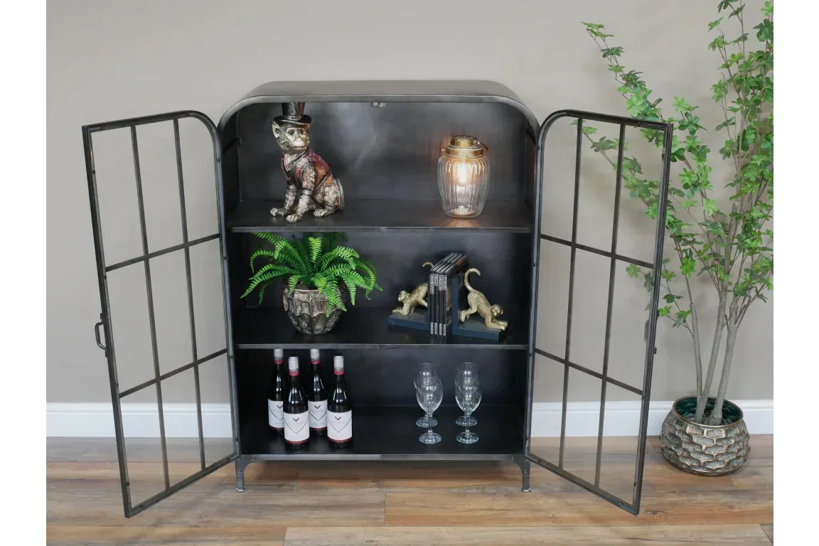 Black metal display cabinet with glass doors, shelves styled with decor and wine bottles