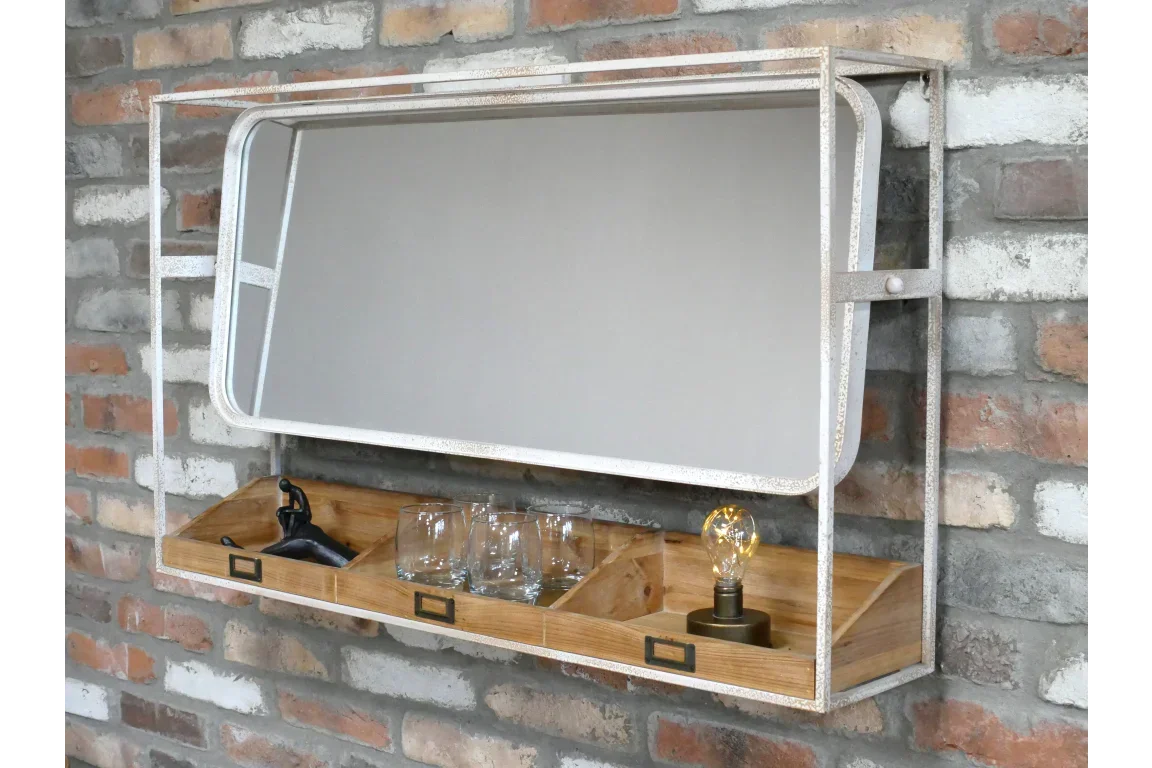 Industrial wall mirror with wooden storage shelf, glasses, lamp, and decor on brick wall