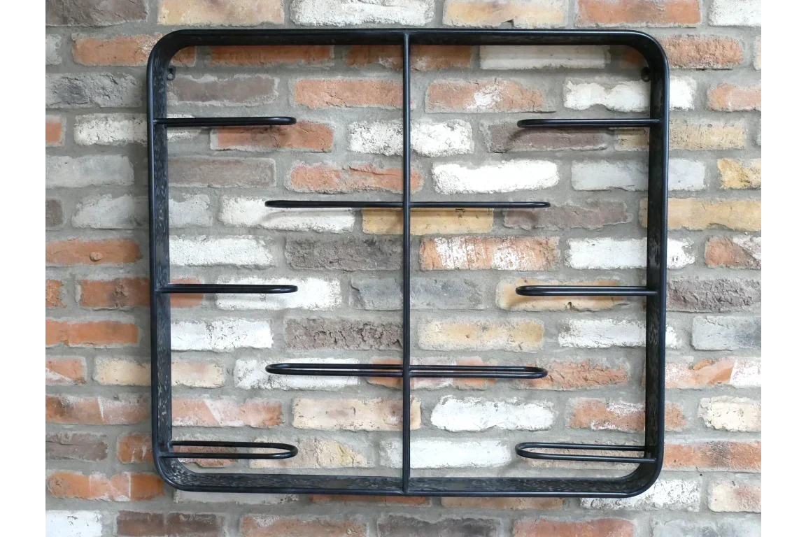 Black metal wall shelf with six horizontal bars mounted on exposed brick wall