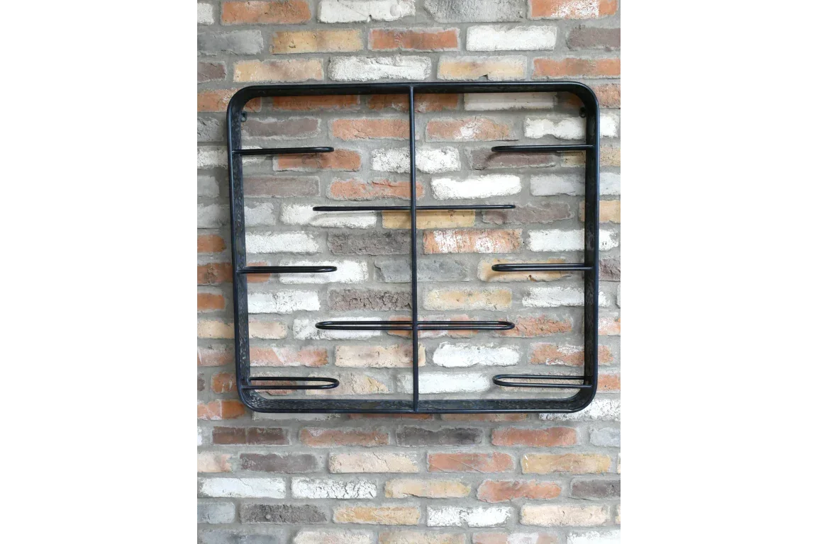 Black metal wall-mounted shelf with six horizontal bars on brick wall