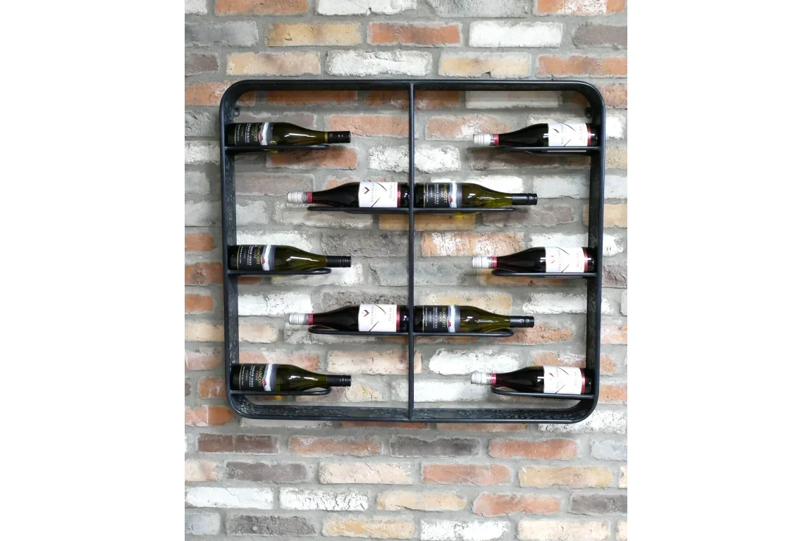 Wall mounted metal wine rack with wine bottles on exposed brick background