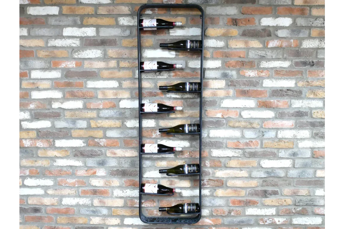 Black metal wall wine rack holding eight bottles against exposed brick wall