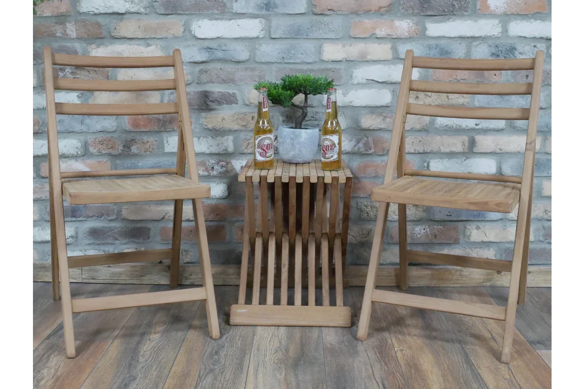 Wooden folding chair set with matching slatted side table, two drinks and potted plant