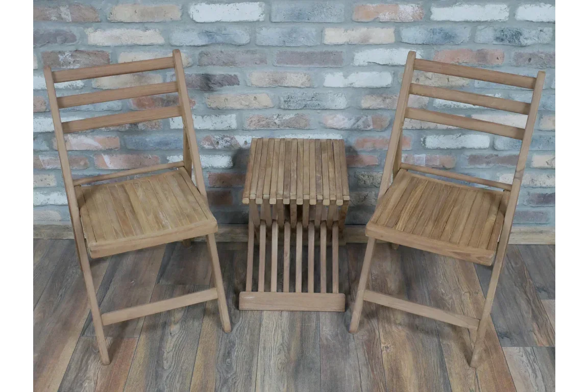 Wooden folding chairs set with matching slatted side table on wooden floor