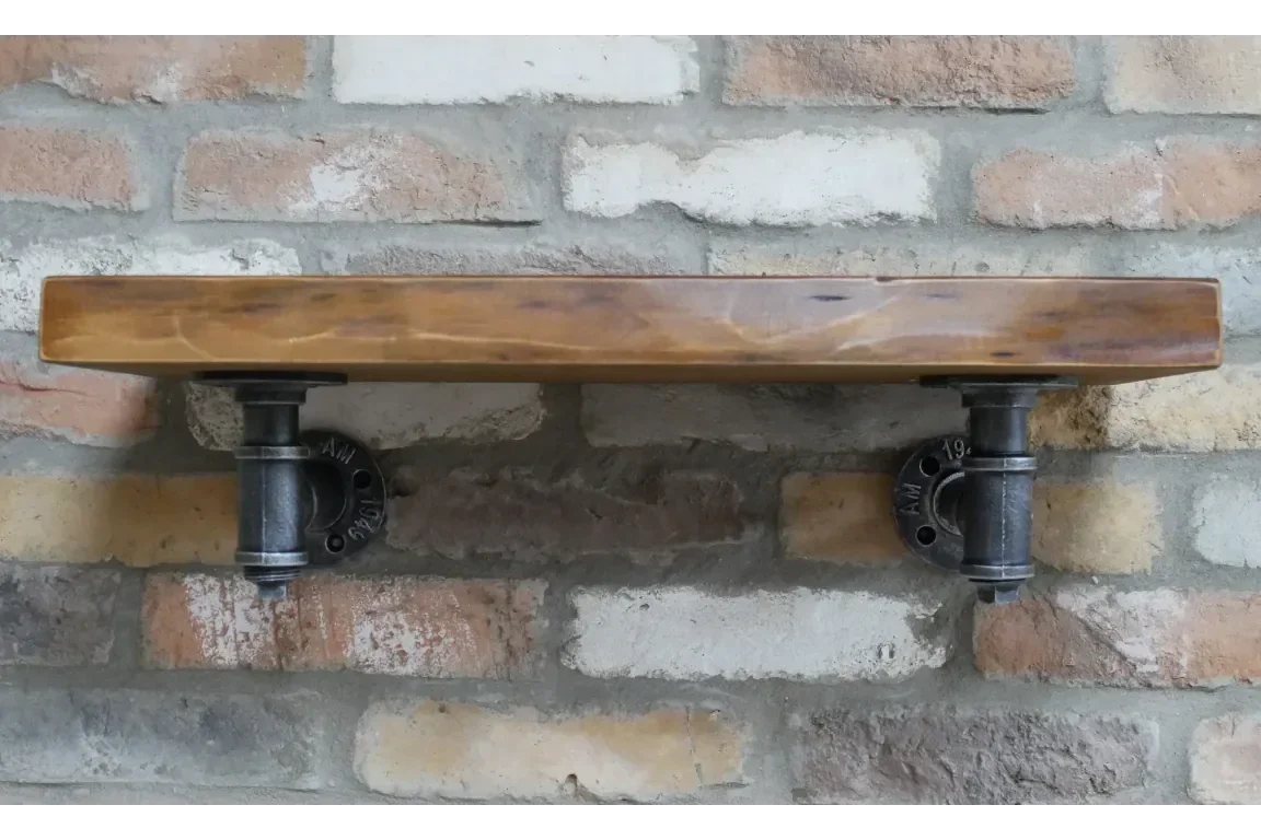 Industrial style wall shelf with solid wood and black metal pipe brackets on brick wall