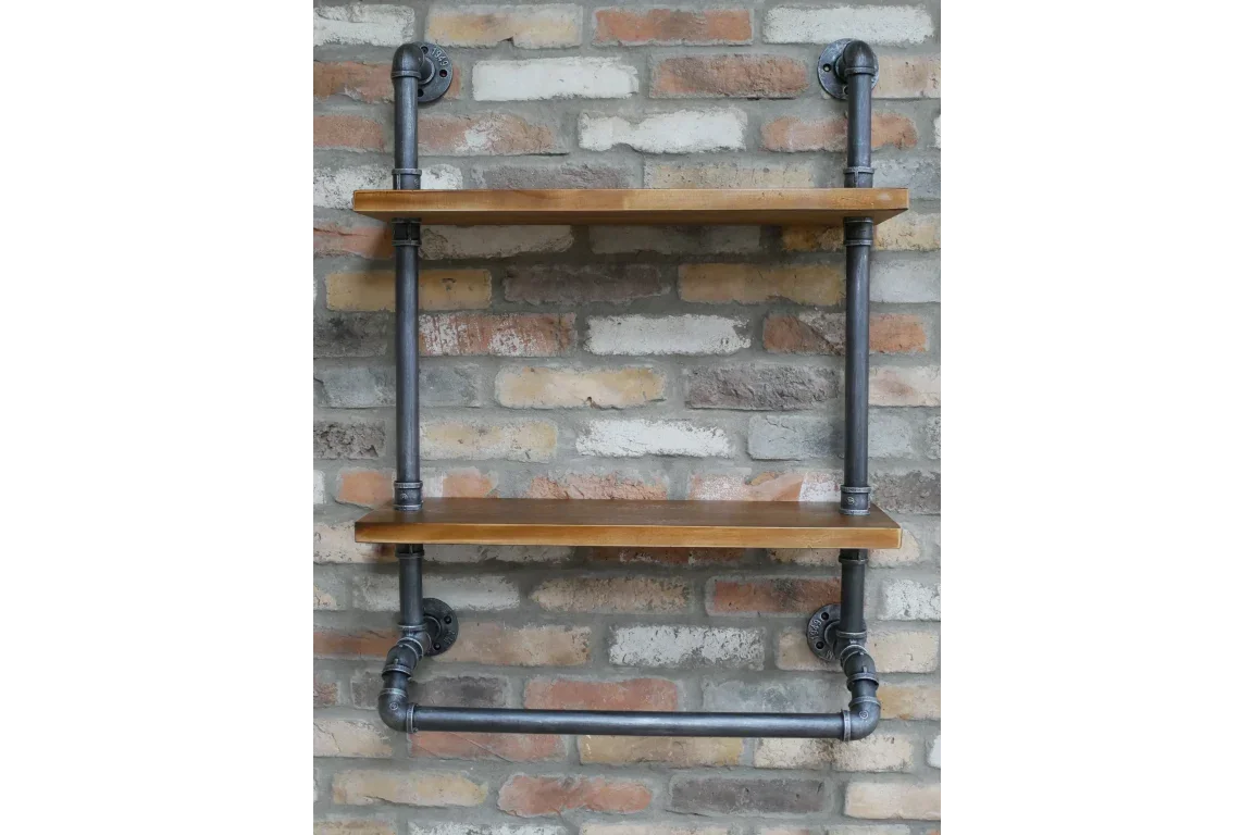 Industrial wall shelf with wooden planks and black metal pipe brackets on brick background