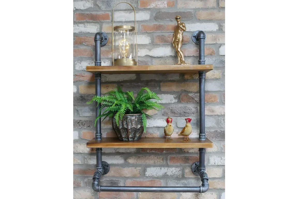 industrial pipe wall shelf with wood boards, holding plant, lantern, and gold figurines