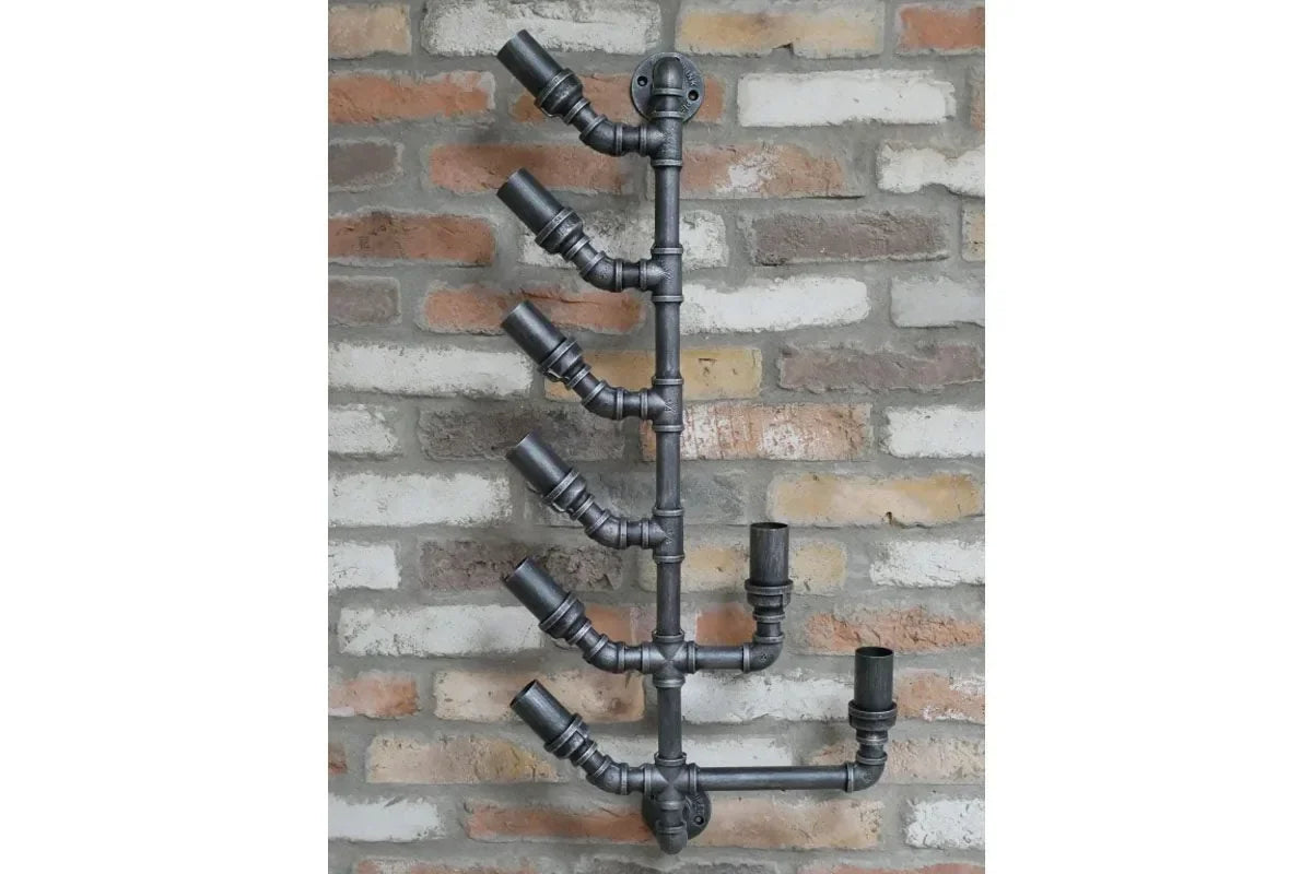 Industrial black metal pipe wine rack mounted on exposed brick wall