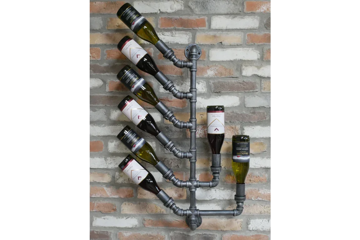 Industrial pipe wall mounted wine rack holding eight bottles against exposed brick wall