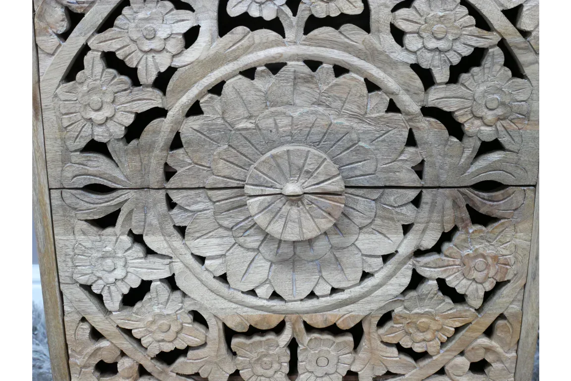 Handcrafted wooden furniture panel with intricate floral carving in natural finish