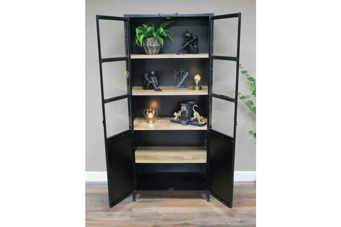 Black metal and wood display cabinet with glass doors and shelves styled with home decor