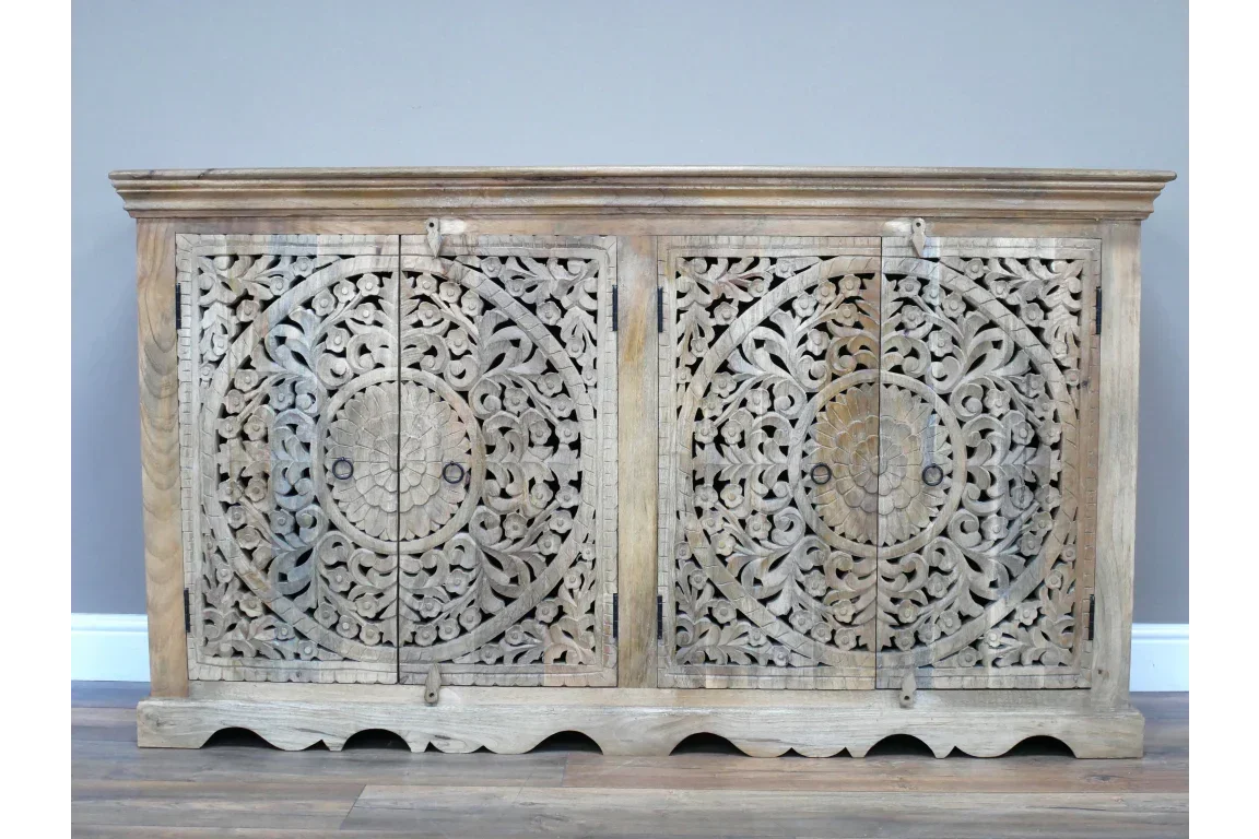 Carved wooden sideboard with ornate floral pattern and double doors, light wood finish