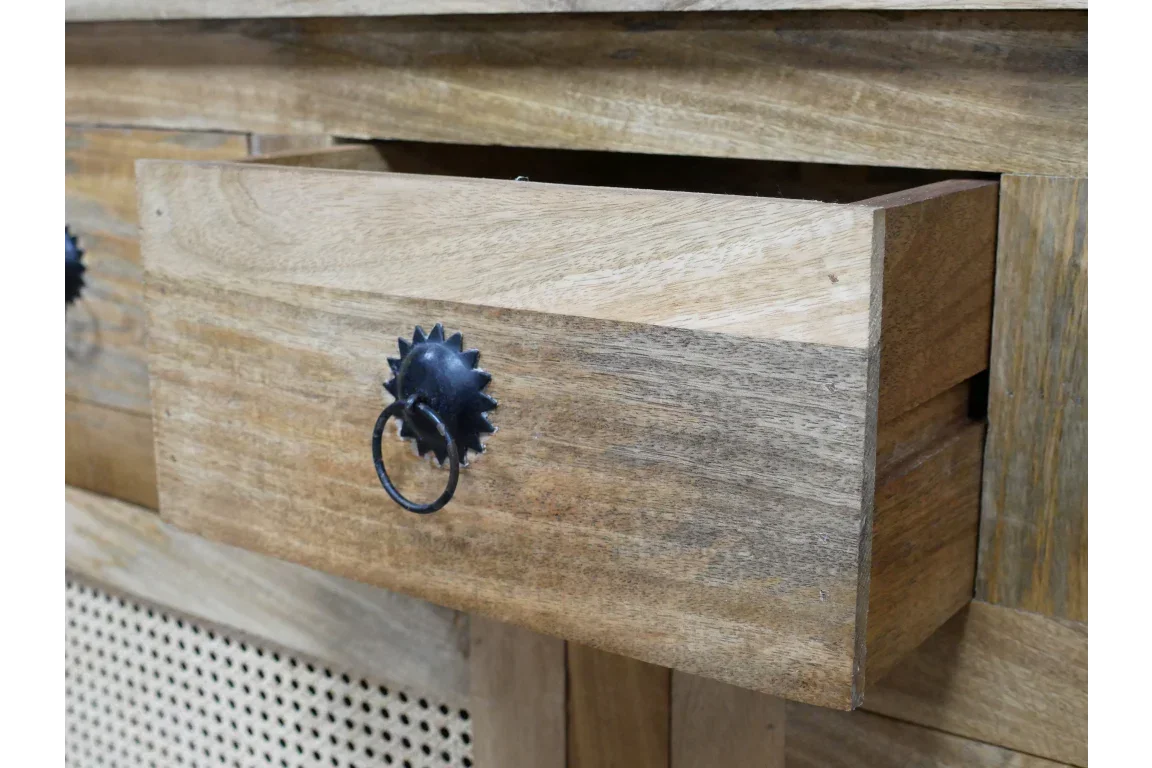 Solid wood drawer with black metal ring handle and cane panel detail on furniture piece