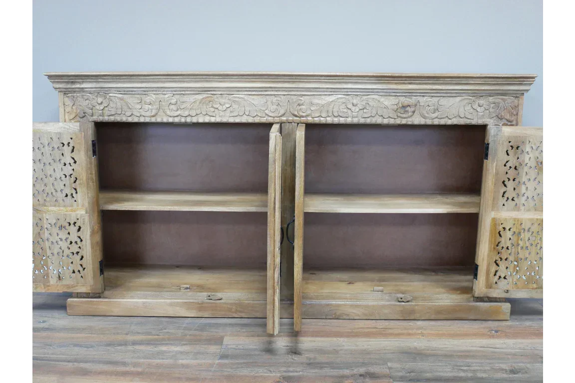 Carved wooden sideboard with open doors, interior shelf, and ornate detailing on top