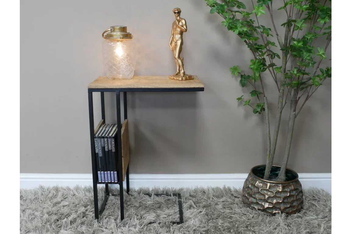 Industrial side table with black metal frame, wood top, magazine rack, and lamp decor
