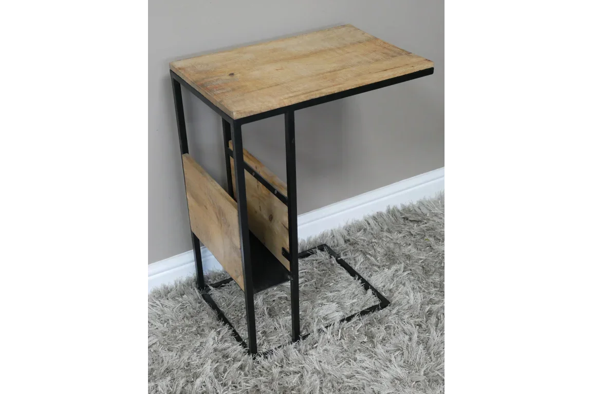 Industrial side table with black metal frame and rustic wood top on grey rug