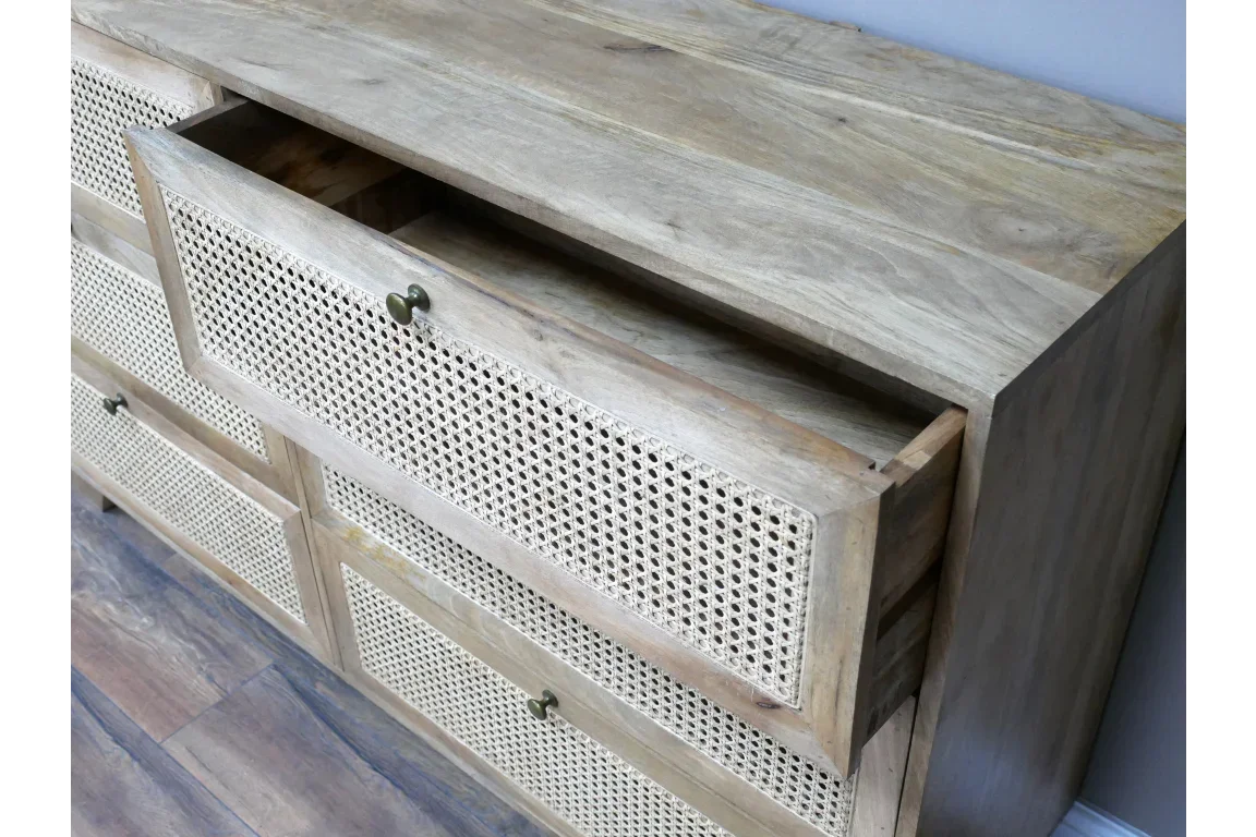 Wooden chest of drawers with rattan fronts and brass handles, top drawer open