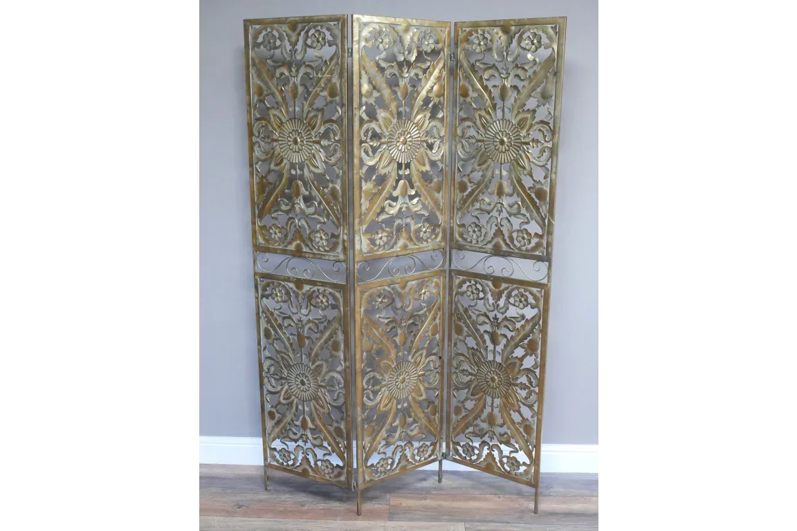 Four panel metal room divider with gold floral pattern and intricate cutout details