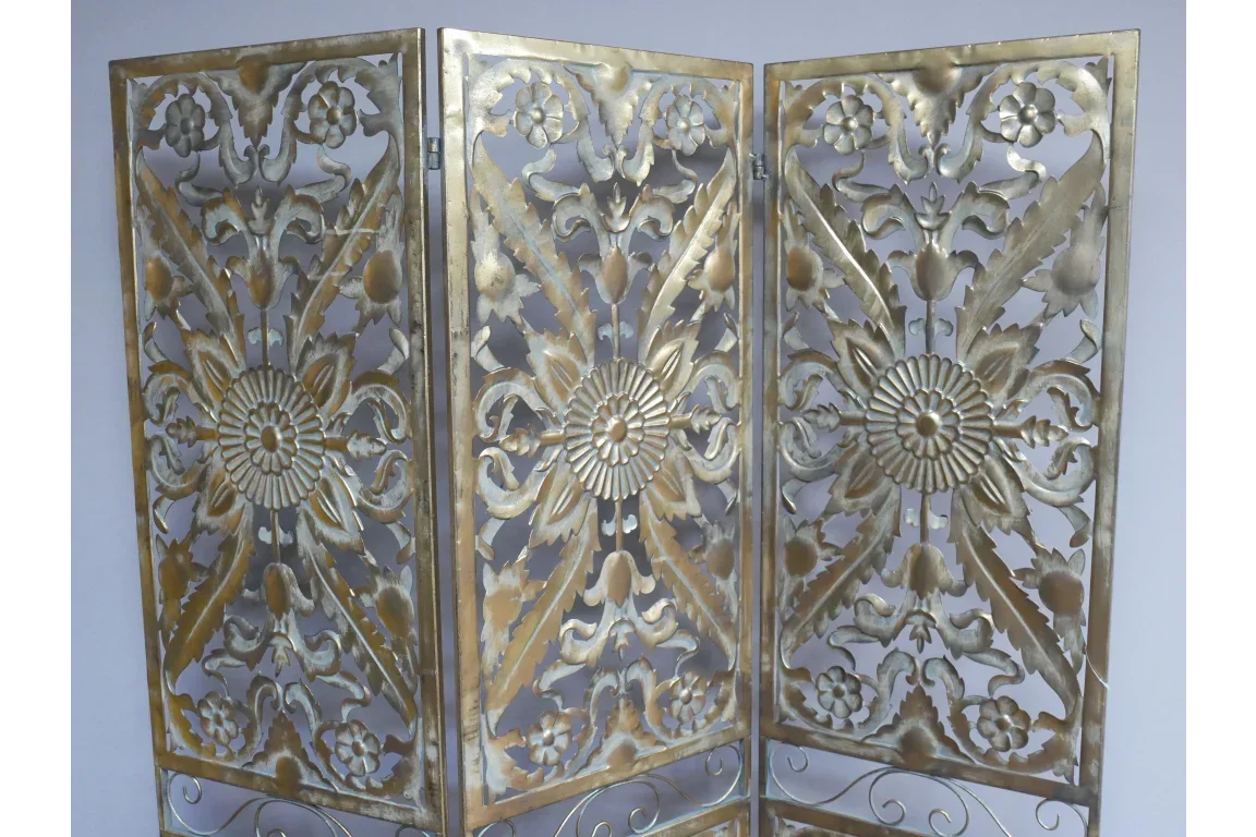 Gold metal folding room divider with ornate floral and geometric cut-out design