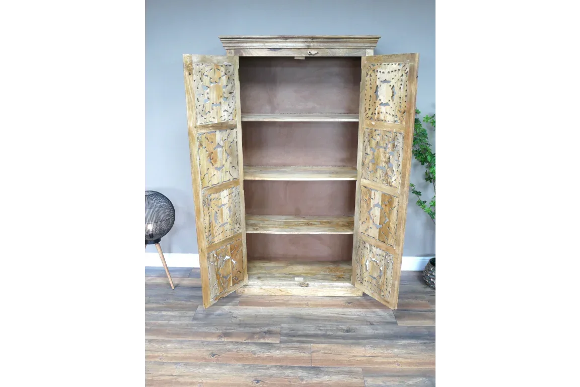 Rustic wood storage cabinet with open carved doors and three shelves in living room