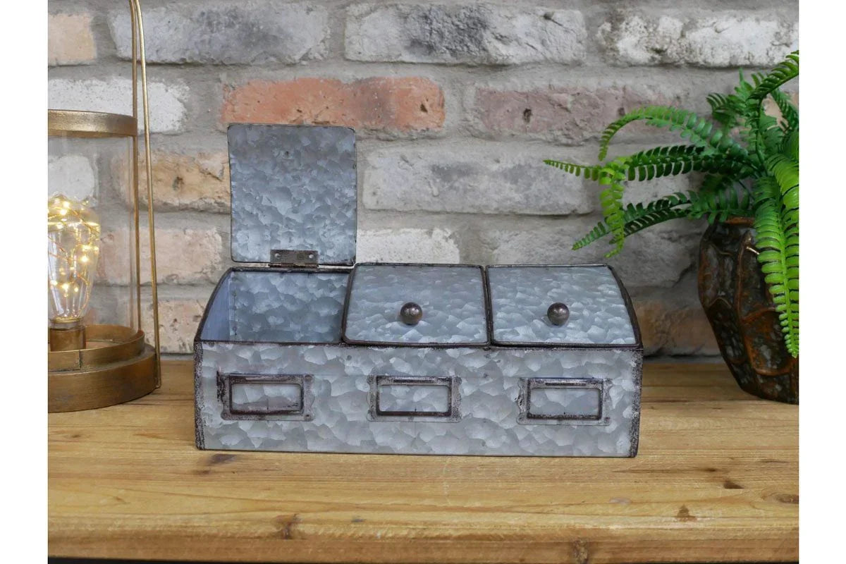 Galvanised metal kitchen storage box with three lidded compartments on wooden countertop