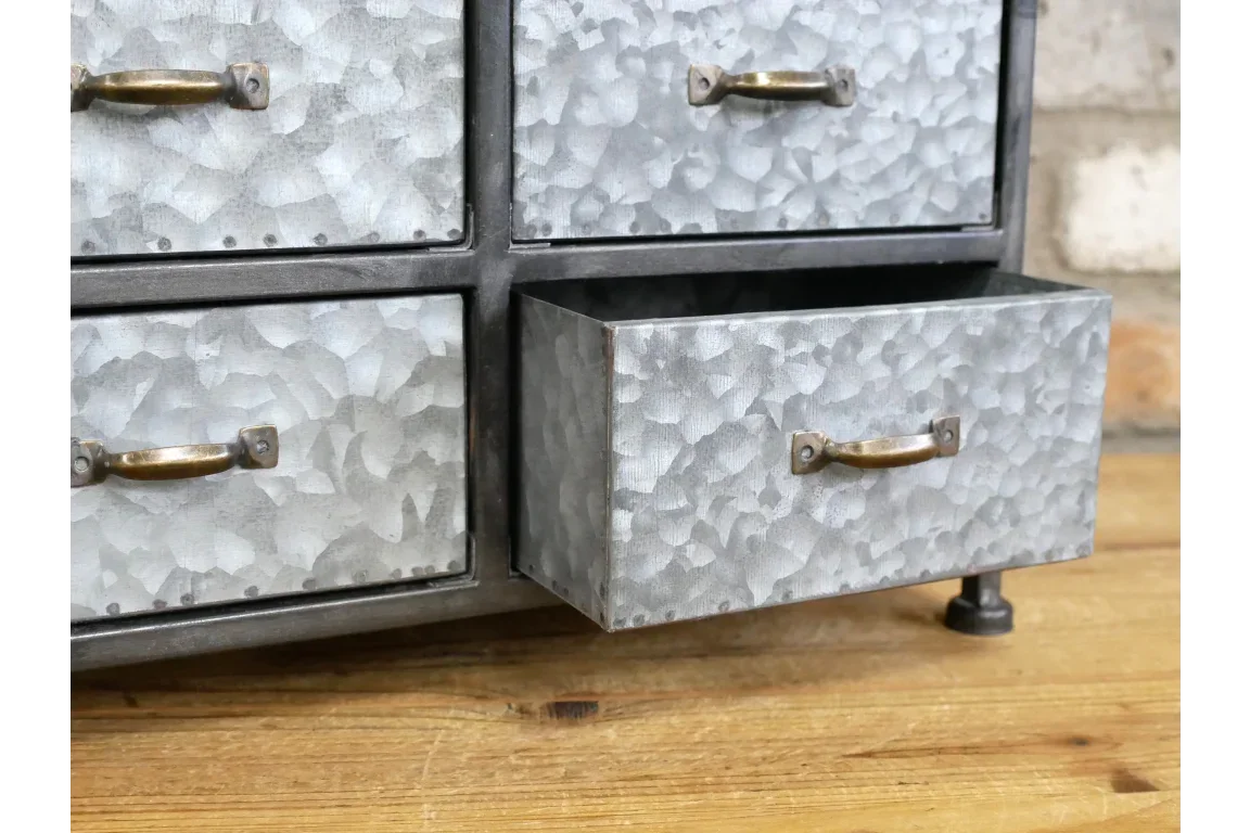 Galvanised metal storage drawers with brass handles on oak tabletop