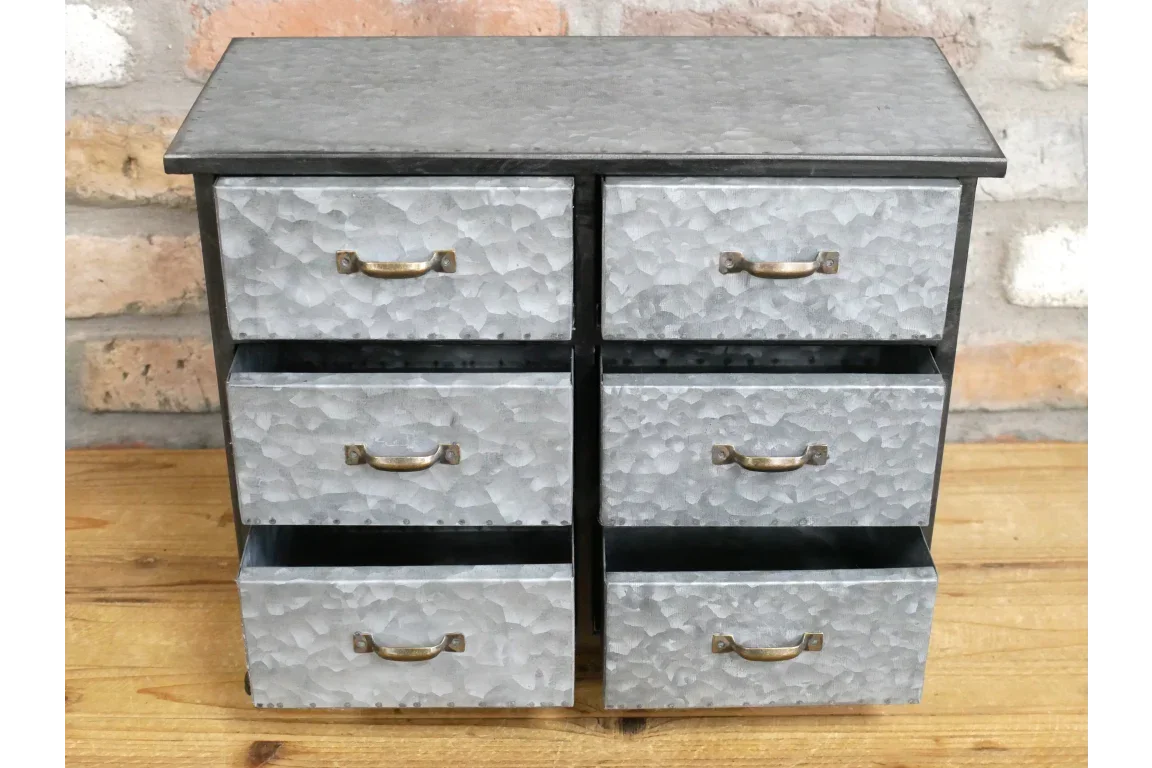Galvanised metal storage drawers with six compartments and brass handles on wooden surface
