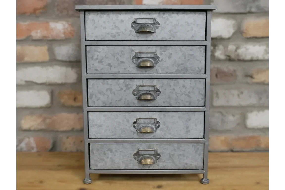 Galvanised metal chest of five drawers with vintage handles on wooden surface