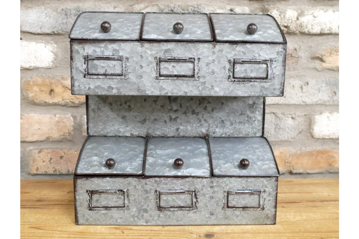 Galvanised metal storage drawers with six compartments on wooden surface