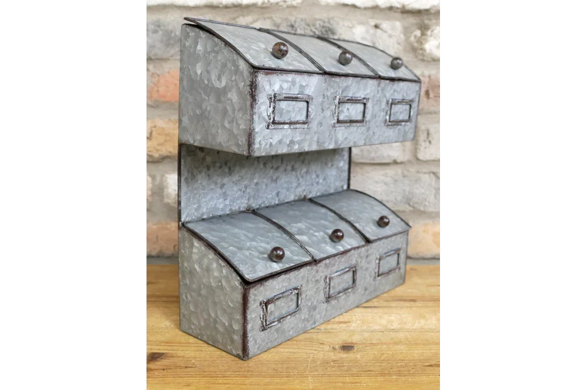 Galvanised metal storage organiser with six compartments on wooden table against brick wall