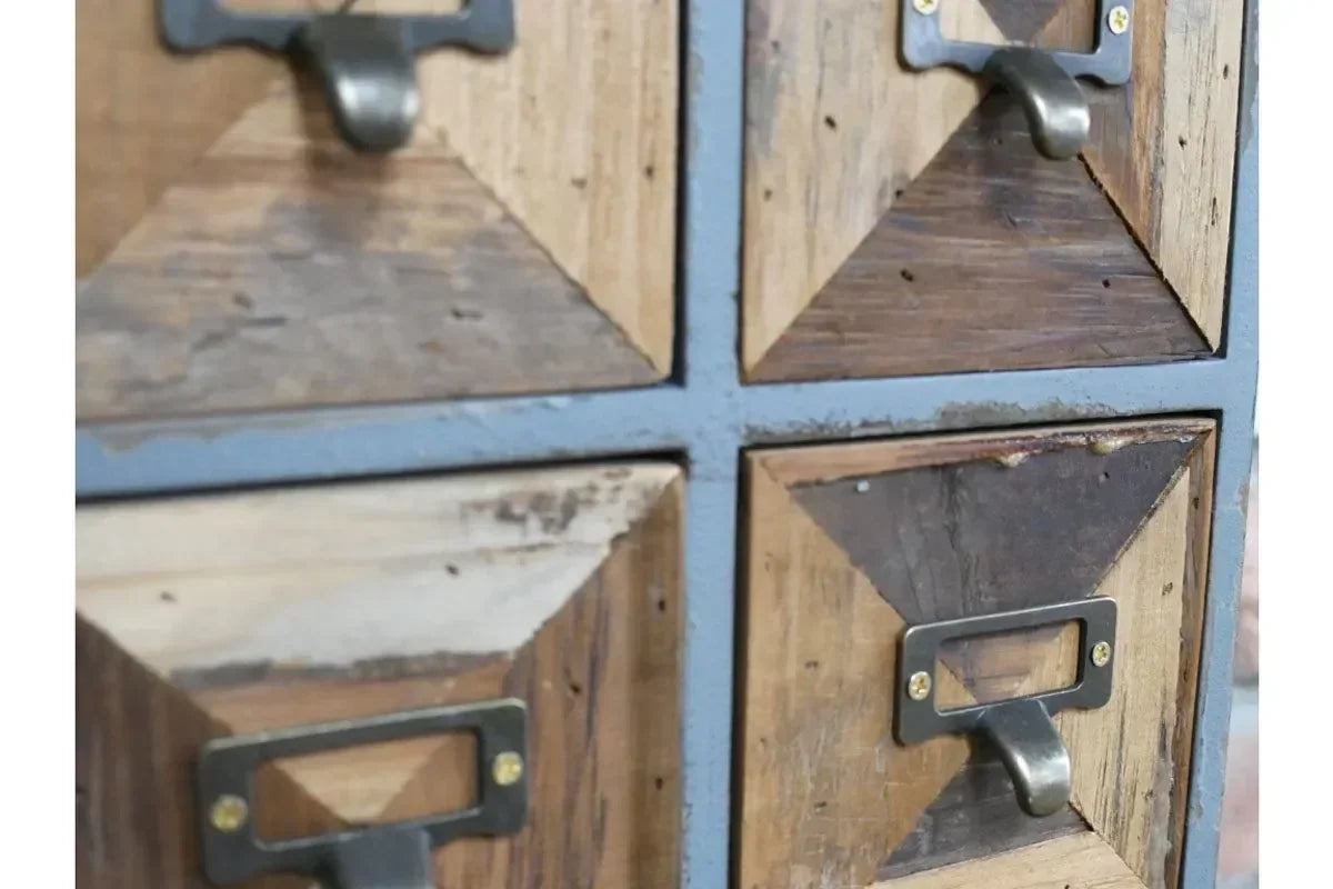 Close-up of rustic wood drawer unit with metal handles and geometric panel design